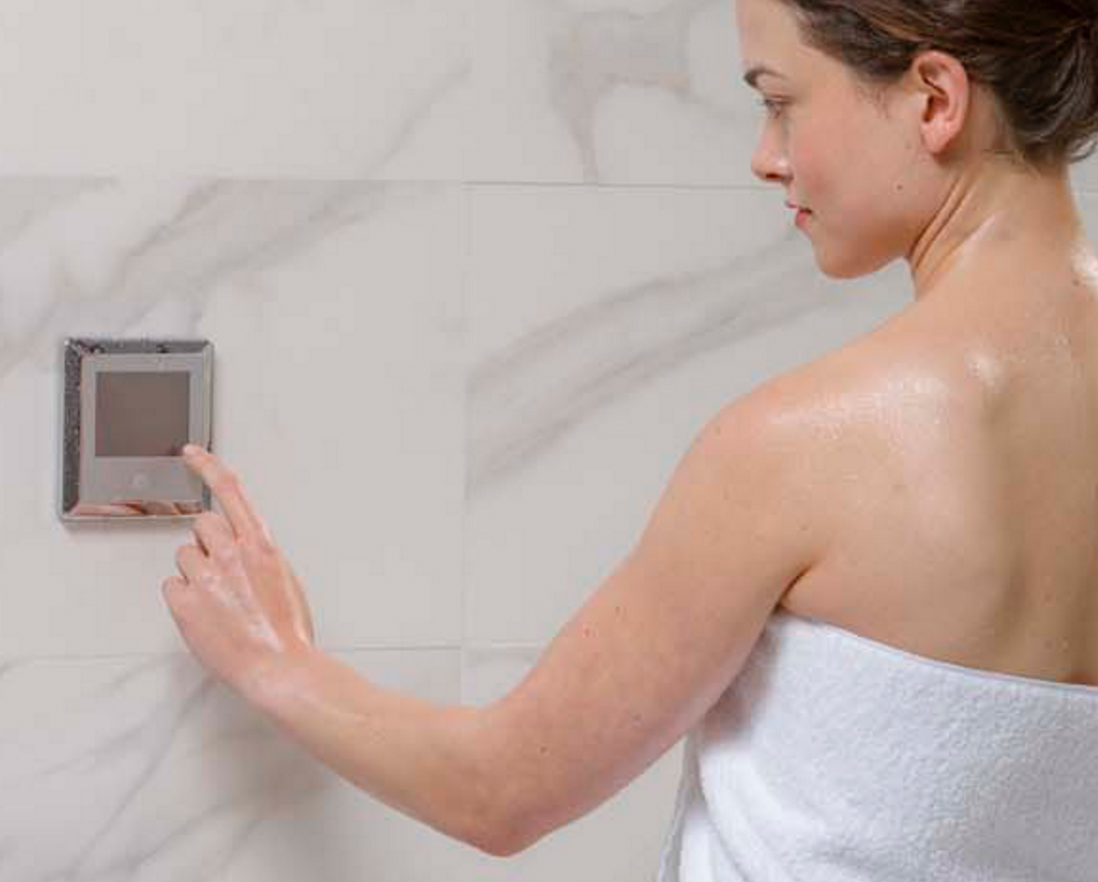 Woman adjusting Steamist Steam Shower settings
