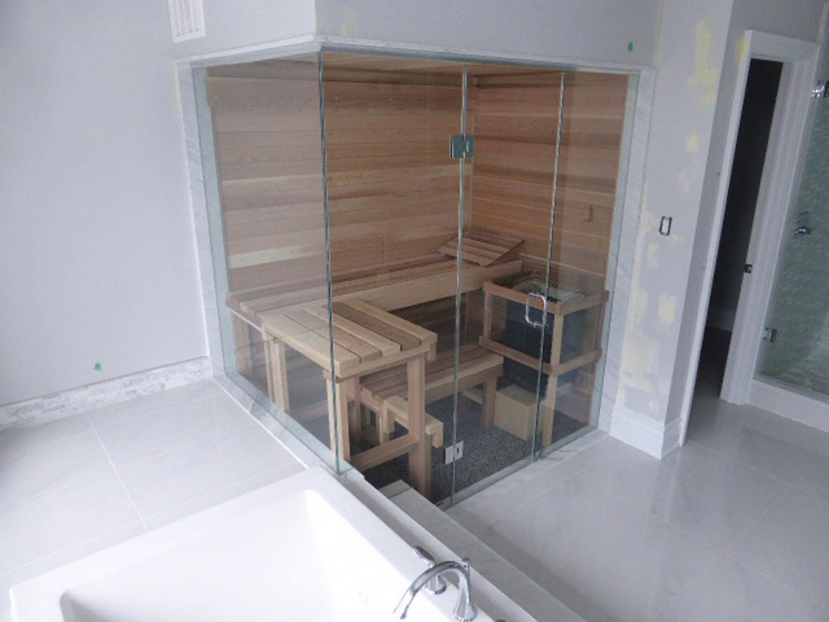 Frameless glass wall sauna with 2 tier bench