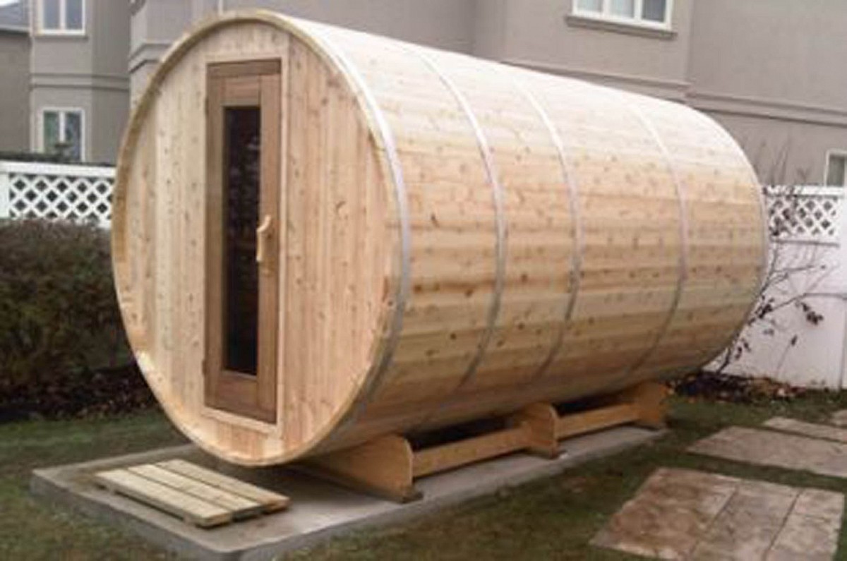 Outdoor knotty barrel sauna with change room