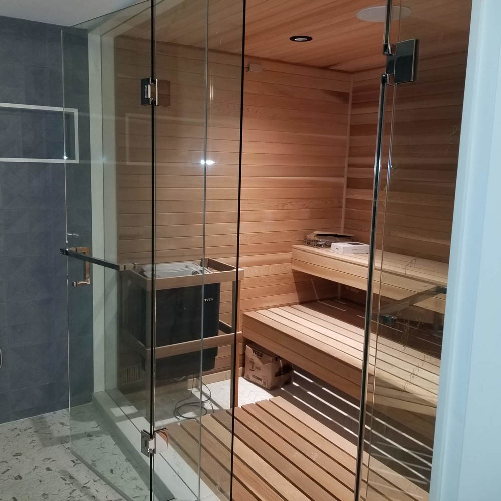 Home sauna with frameless glass and large floating bench