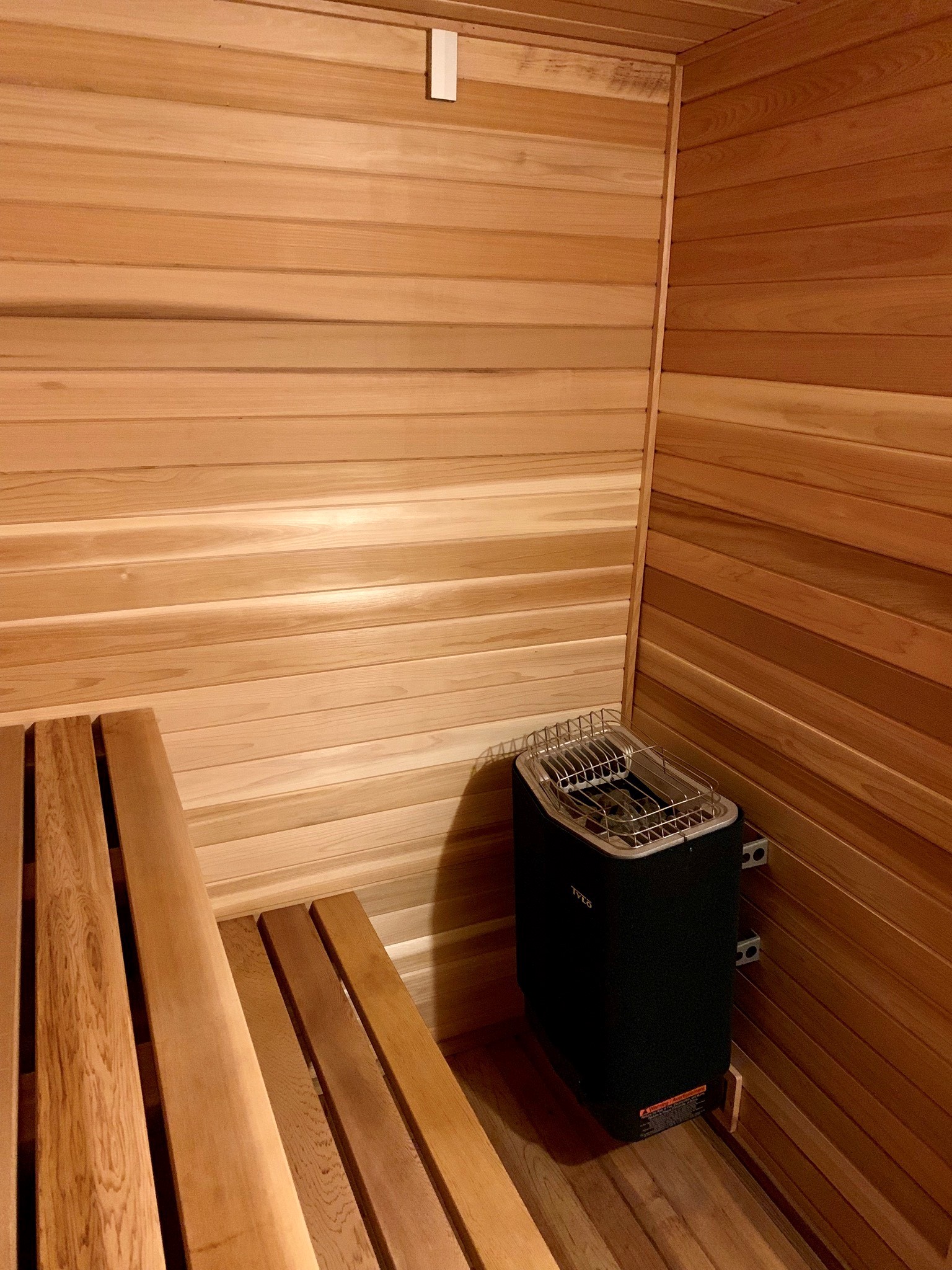 home sauna with cedar floor and tylo sauna heater