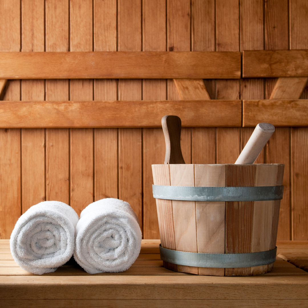 Rolled up towel and sauna bucket in side a wooden sauna